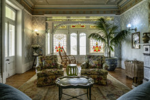 One of the main sitting rooms, complete with wallpaper, chintz and stained-glass window panes.