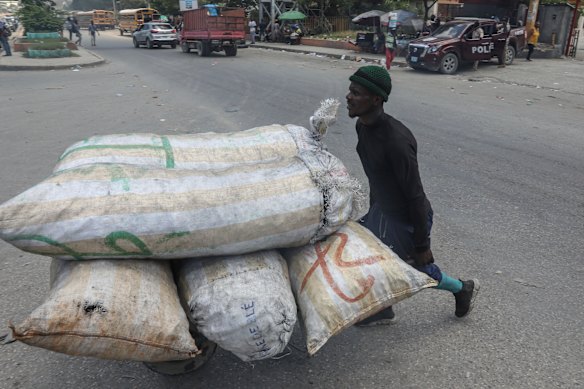 A vendor pushes a wheelbarrow loaded with sacks of charcoal in Port-au-Prince, Haiti.