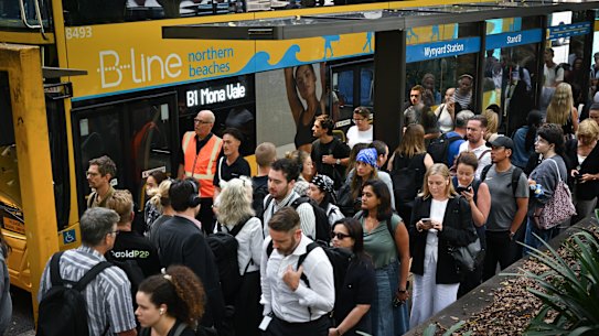 Commuters wait in a snaking line for B-line buses to the northern beaches at Wynyard station.