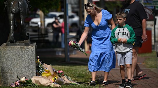 People lay flowers at a makeshift memorial in Daylesford.