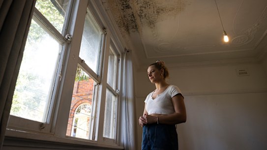 Holly Konopka in her rented Coogee apartment with mould and mushrooms growing on the ceiling.