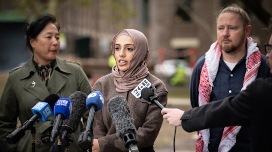 alestinian Action Group members Josh Lees and Amal Naser (speaking) with NSW Greens Jenny Leong.