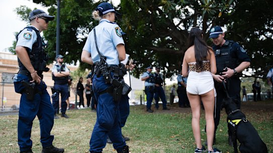 A file image of an attendee and police at the Field Day Festival in Sydney in January 2020.