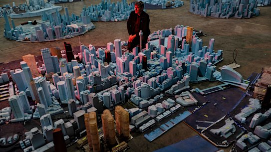 Dr Matt Glanville,  the founder of CPP Wind in Australia, with a scale model of Sydney in the company’s laboratory. 