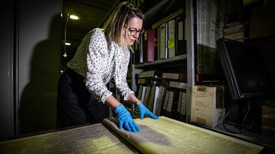 Sydney Morning Herald Editor Jordan Baker looking at items in the Fairfax archives.
