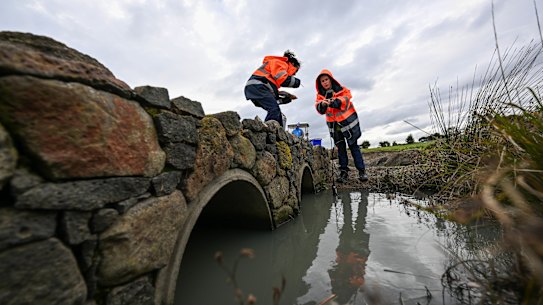 EPA workers on Thursday testing a creek that runs through the Mt Derrimut golf course after the blaze.