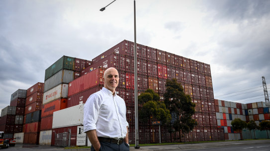 Andrew Coldrey, vice-president for the Asia Pacific region of global logistics firm CH Robinson, in front of stacks of empty shipping containers at the port.