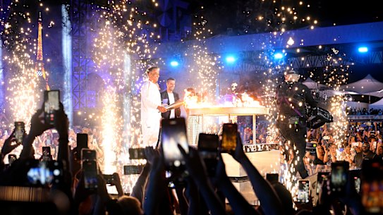 PARIS, FRANCE - JULY 26: Jessica Fox and Eddie Ockenden, Flagbearers of Team Australia, are seen on a boat waving their flag along the River Seine during the opening ceremony of the Olympic Games Paris 2024 on July 26, 2024 in Paris, France. (Photo by Quinn Rooney/Getty Images)