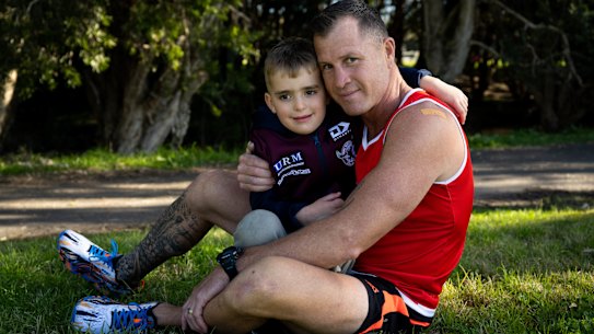 Shannon Ponton, a trainer on The Biggest Loser, with his son, Bronx, in Sydney. He is training for the Sun Herald City to Surf, as an ambassador for Cure Cancer, inspired by a scare they had with his son’s health. 29th July 2022 Photo: Janie Barrett