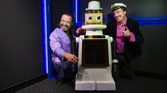 Conor Gallacher and Alex Reid with “robot love predictor” Dexter  are bringing back the dating game show.