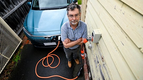 Policy consultant Bryce Gaton charging his electric vehicle. 