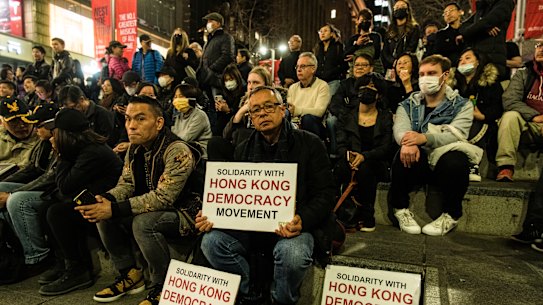 Protesters hold pro-Hong Kong signs at the 'Stand With Hong Kong' rally at Martin Place on Friday night.