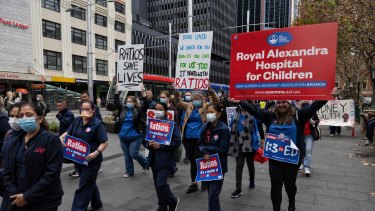 Unionised nurses and midwives arrive at Sydney Town Hall for their meeting on Tuesday.