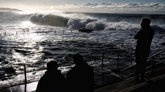 Spectators watch the monster waves roll in at  Dee Why early on Monday.
