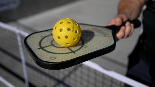 Pickleball racquets are a super-light paddle, bigger than a table tennis bat but smaller than a tennis racquet. The balls are made of perforated plastic.
