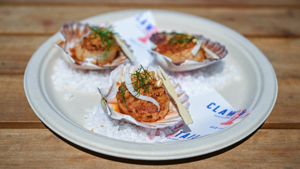 Scallops on their shells with ’nduja and pine nut crumb.