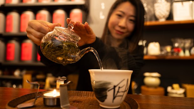 Founder of Ms. Cattea Cathy Zhang prepares Nine Mountains green tea on a candle burner.