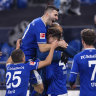 Schalke team members with from left: Amine Harit, Schalke's Sead Kolasinac, goal scorer Matthew Hoppe, coaching staff Naldo, and Mark Uth celebrate their second goal goal against Hoffenheim, during their German Bundesliga FC Schalke 04 - 1899 Hoffenheim soccer match at Veltins Arena in Gelsenkirchen, Germany, Saturday Jan. 9, 2021.  (Guido Kirchner/dpa via AP)