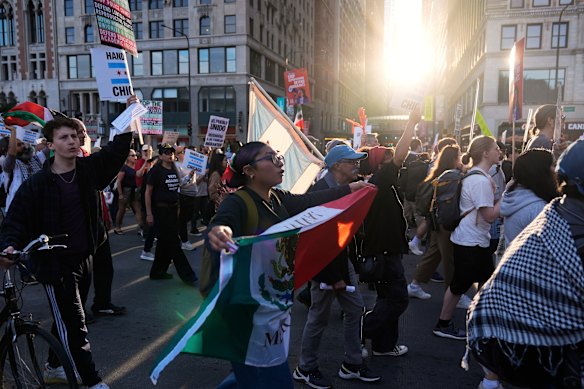 Demonstrators march at a protest opposing “Operation Midway Blitz” and the presence of ICE in Chicago.