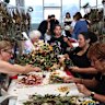 More than 100 volunteers are busy at work preserving items left at the memorial at Bondi Pavilion.