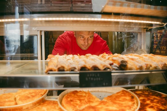 Co-owner Jovan Radevski stocks the cabinet at Burek Brothers.