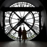 China’s President Xi Jinping’s wife Peng Liyuan, right, and French President Emmanuel Macron’s wife Brigitte Macron pose in front of the clock as they visit the Orsay Museum in Paris.