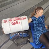 Protester Sarah locked her arm in a concrete barrel outside the Woodside building in Perth, in protest of the Scarborough gas project. 
