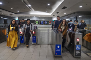 Commuters move through Green Square train station on Tuesday morning.