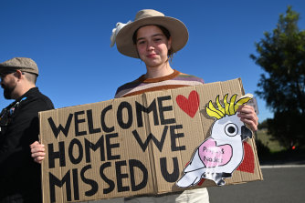 Isabelle Kelleher holds a welcome sign ahead of the Murugappan family’s return to Biloela.
