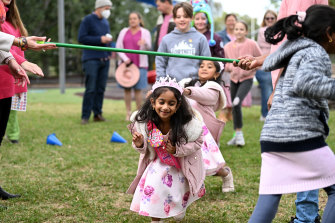 Tharnicaa Nadesalingam plays a game during her fifth birthday party in Biloela.