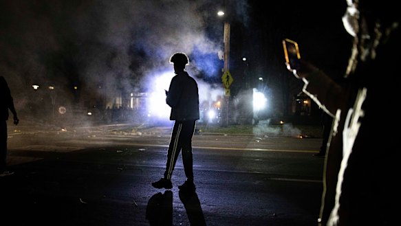Protesters confronts with police in front of the Brooklyn Centre Police station on Sunday.