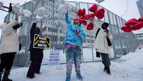 Damik Bryant, brother of Daunte Wright, centre, and friends release balloons after the three former Minneapolis police officers were found guilty of depriving George Floyd of his right to medical care.
