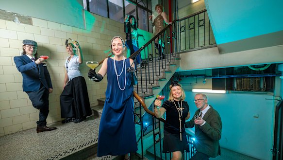 Anna Prifti (front), Stephen McLaughlan (right) and tenants hold a 1920s-style party to celebrate the centenary of the Nicholas Building.