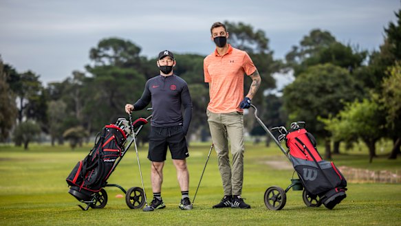 Shane Nolan (left) and Anthony Carden hit Albert Park Golf Course on Wednesday, shortly after restrictions eased. 