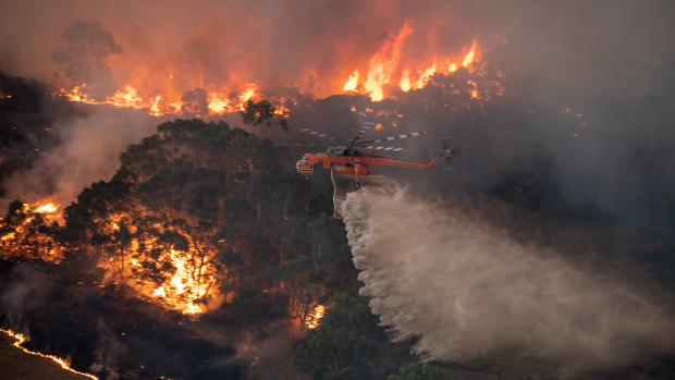 A firefighting helicopter tackling a bushfire near Bairnsdale in Victoria's East Gippsland.