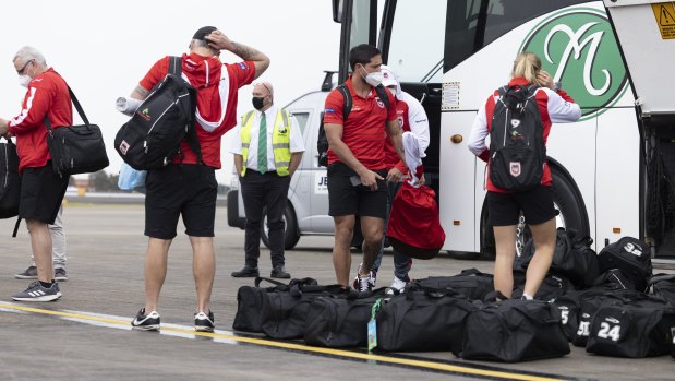 Dragons players and staff at Sydney airport during the week to board a flight to Queensland.