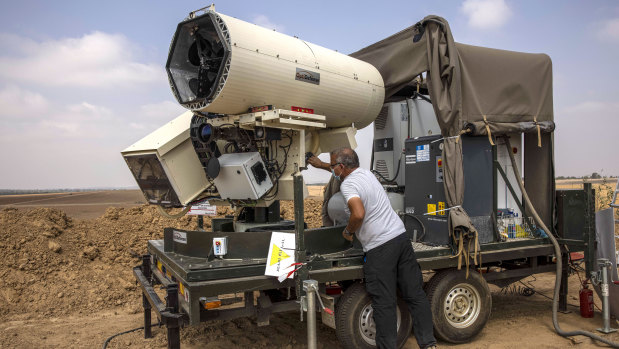 An Israeli police officer demonstrates a new laser defence system designed to intercept explosives-laden balloons launched from the Gaza Strip into Israel.
