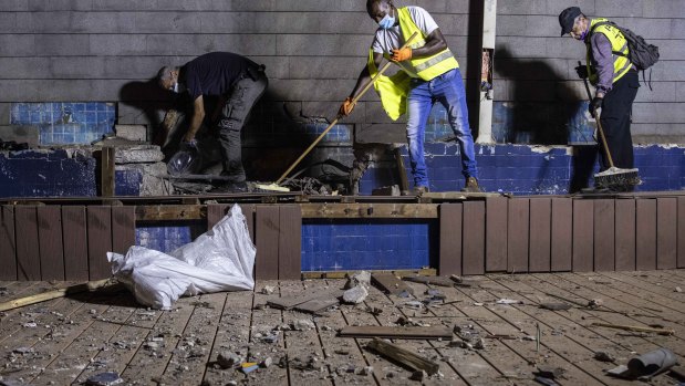 Israeli police inspect the damage at the site hit by a rocket fired by Palestinian militants from the Gaza Strip in the southern city of Ashdod, Israel.