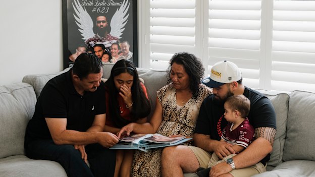 Keith’s dad Paul, sister Zara, mother Lafo, brother Jesse and nephew Hudson looking at family photo albums as they remember the life of their loved one.