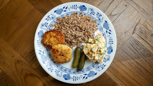 Lunch is kotleti chicken cutlets with buckweat, Olivier salad and pickles.