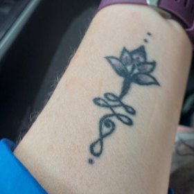 Sue Williams lotus flower tattoo is a symbol of resilience.  
