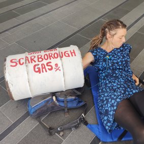 Protester Sarah locked her arm in a concrete barrel outside the Woodside building in Perth, in protest of the Scarborough gas project. 