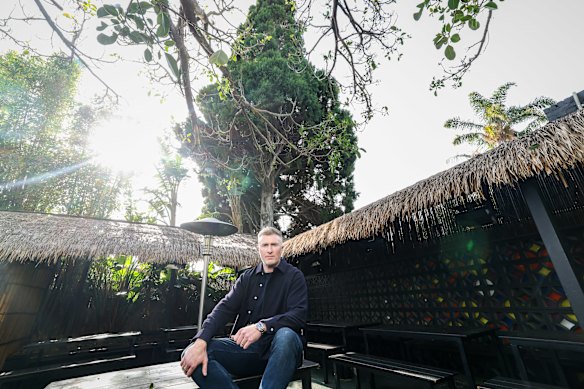 Windsor Castle Hotel owner Liam Ganley in front of the Bhutan Cypress tree which has been a subject of dispute with Stonnington Council.
