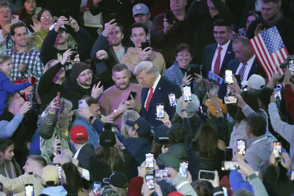 Trump is welcomed by the crowd on arrival at the rally.