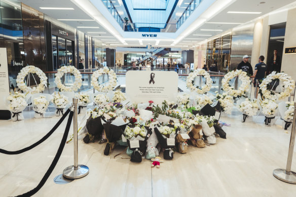 Mourners left floral tributes at a temporary memorial.