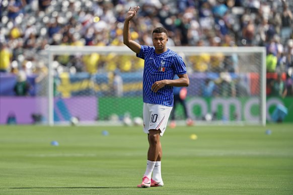 Kylian Mbappe warms up ahead of France’s elimination match against Sweden.