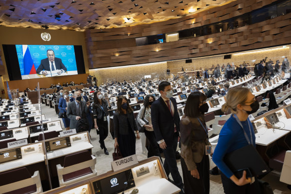 Ambassadors and diplomats leave the room while Russia’s foreign minister Sergei Lavrov (on screen) addresses with a pre-recorded video message the Conference on Disarmament in Geneva on Tuesday.