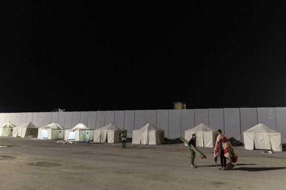 Volunteers and staff at a camp in front of the Rafah border as they wait to deliver aid and supplies to Gaza.