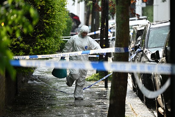 A forensics officer works at the scene of the fire in Kentish Town, north London.