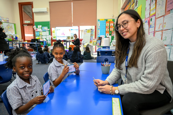 Tutor Wendy Martin with students Jasmine and Kokob at Collingwood’s St Joseph’s Primary School.